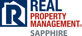 Logo of real property management sapphire, featuring bold, blue and red text with a stylized 